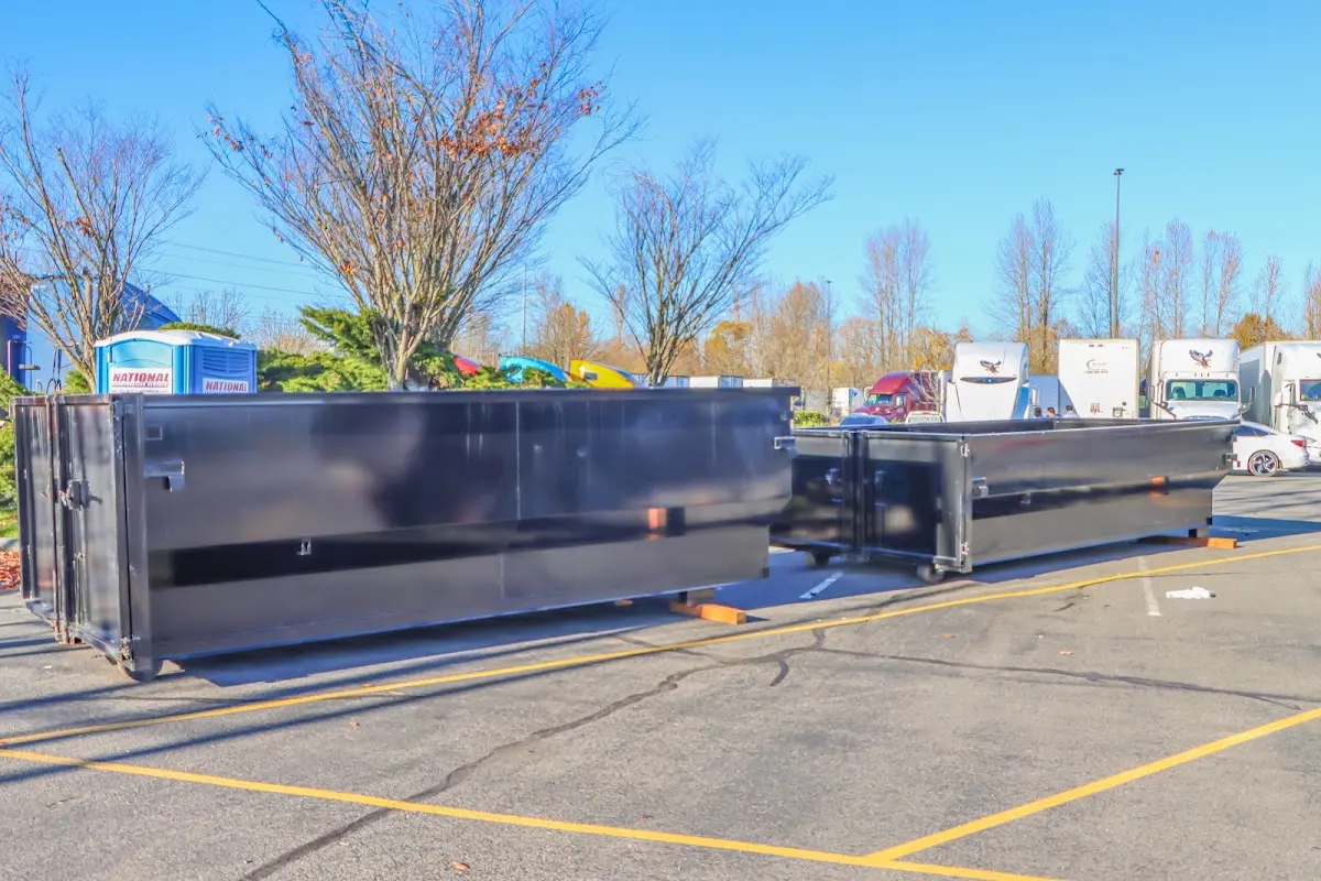 Professional dumpster rental service with roll-off container on residential driveway in Stratham